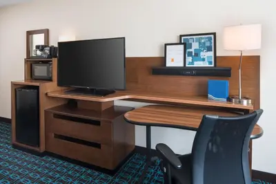 a computer desk with a monitor and a chair at Fairfield Inn by Marriott Loveland Fort Collins in Loveland