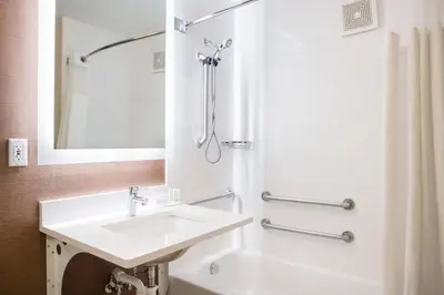 a white bathroom with a sink and a shower at Fairfield Inn by Marriott Loveland Fort Collins in Loveland