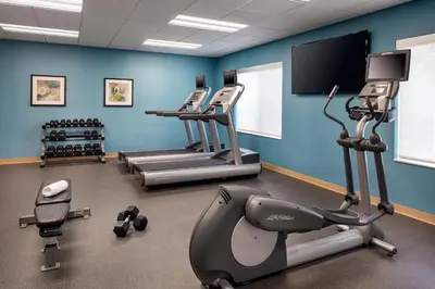 a gym with tread machines and a flat screen tv at Fairfield Inn by Marriott Loveland Fort Collins in Loveland