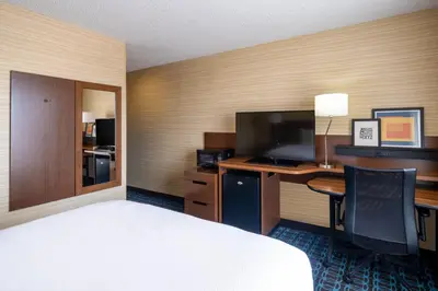 a hotel room with a bed and a desk with a computer at Fairfield Inn & Suites by Marriott Denver Aurora/Medical Center in Aurora