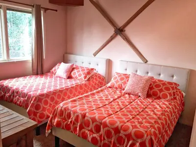 a bedroom with two beds with red and white sheets at Condo Right On Main Street By Daniel in Frisco