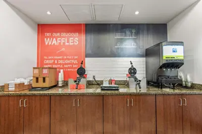 a kitchen with a counter top and avertisement at Hampton Inn Denver Northeast-Brighton in Brighton