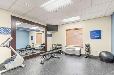 a gym with treadmills and machines in a room at Hampton Inn Denver Northeast-Brighton in Brighton