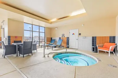 a hot tub in a room with chairs and a table at Hampton Inn Denver Northeast-Brighton in Brighton
