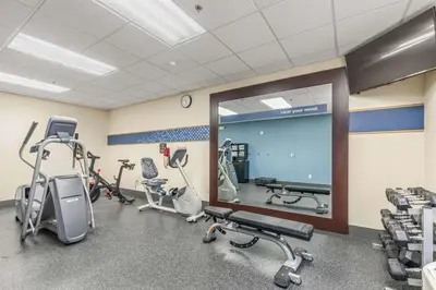 a gym with several treadmills and elliptical machines at Hampton Inn Denver Northeast-Brighton in Brighton