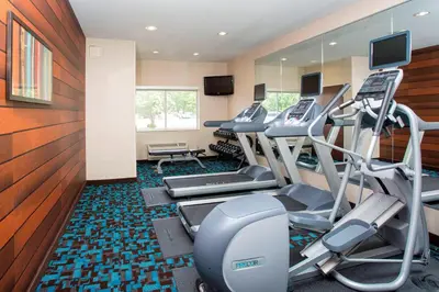 a fitness room with treadmills and elliptical machines at Fairfield Inn & Suites Greeley in Greeley