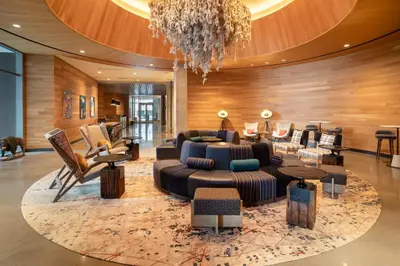 a lobby with a couch and chairs and a chandelier at Hotel Indigo Denver Downtown - Union Station by IHG in Denver