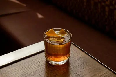 a drink sitting on top of a wooden table at Hotel Indigo Denver Downtown - Union Station by IHG in Denver