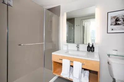 a bathroom with a sink and a shower and a toilet at Hotel Indigo Denver Downtown - Union Station by IHG in Denver