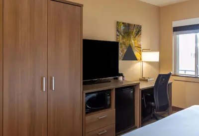a bedroom with a large cabinet with a television on it at Boulder University Inn in Boulder