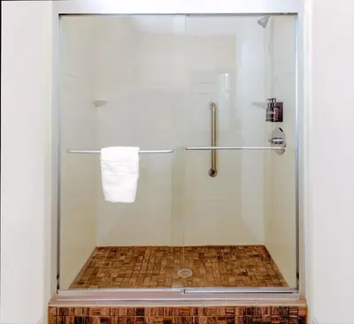 a shower with a glass door in a bathroom at Boulder University Inn in Boulder