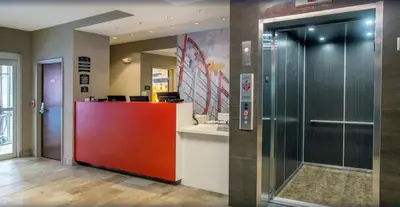 an office lobby with a red door and a counter at Staybridge Suites Denver Downtown by IHG in Denver