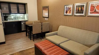 a living room with a couch and a table at Staybridge Suites Denver Downtown by IHG in Denver