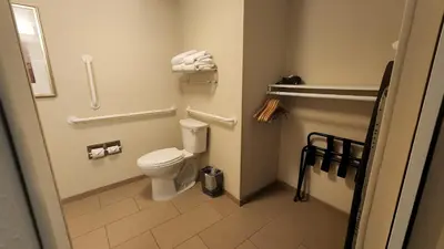 a small bathroom with a toilet and towels at Staybridge Suites Denver Downtown by IHG in Denver