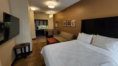 a hotel room with a bed and a chair at Staybridge Suites Denver Downtown by IHG in Denver