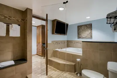 a bathroom with a tub and a toilet and a sink at Grand Z Hotel Casino by Red Lion Hotels in Central City
