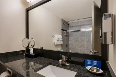 a bathroom with a sink and a mirror at Grand Z Hotel Casino by Red Lion Hotels in Central City