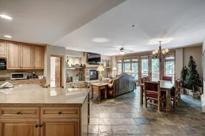 a kitchen and living room with a christmas tree at Timbers & Lone Eagle by Vail Resorts in Keystone