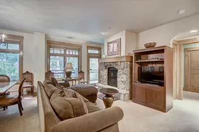 a living room with a couch and a fireplace at Timbers & Lone Eagle by Vail Resorts in Keystone