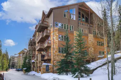 a large apartment building with snow in front of it at Timbers & Lone Eagle by Vail Resorts in Keystone