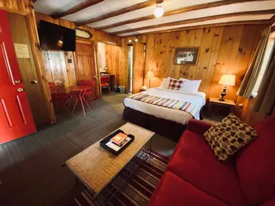 a bedroom with a bed and a couch in a room at Foot of the Mountain Motel in Boulder