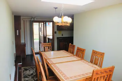 a dining room with a wooden table and chairs at Foot of the Mountain Motel in Boulder