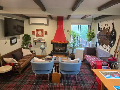 a living room with a couch and a fire place at Foot of the Mountain Motel in Boulder