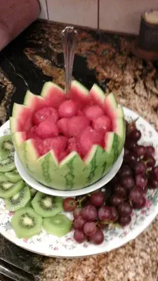 a bowl of watermelon and grapes on a plate at The Silk Pincushion in Golden