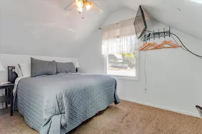 a bedroom with a bed and a window at The Silk Pincushion in Golden