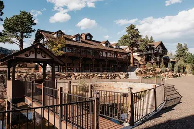 a large building with a fence in front of it at The Landing at Estes Park in Estes Park