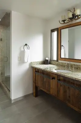 a bathroom with a sink and a mirror and a shower at The Landing at Estes Park in Estes Park