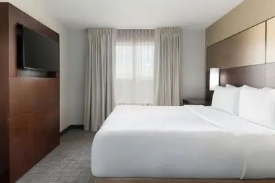 a large white bed in a hotel room at Residence Inn by Marriott Denver Central Park in Denver
