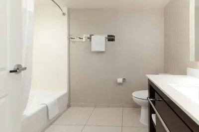 a bathroom with a tub and a toilet and a sink at Residence Inn by Marriott Denver Central Park in Denver