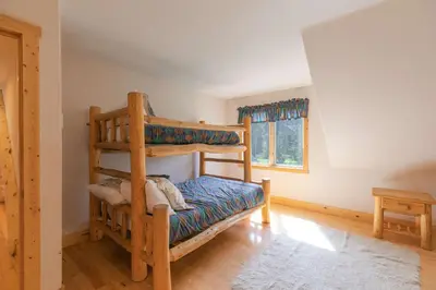 a bedroom with two bunk beds and a window at Hohenmark Haus Home: Great Year-Round Location in Breckenridge
