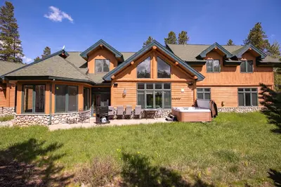 a log home with a hot tub in the yard at Hohenmark Haus Home: Great Year-Round Location in Breckenridge