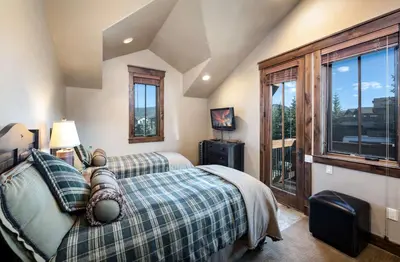 a bedroom with two beds and a window at The Shores Riverside Townhome: Peaceful Luxury in Breckenridge