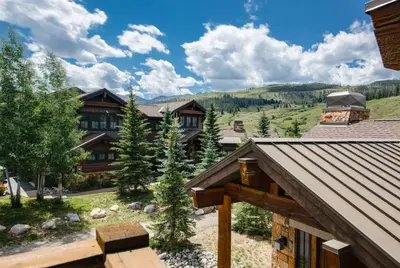 an aerial view of a lodge with mountains in the background at The Shores Riverside Townhome: Peaceful Luxury in Breckenridge