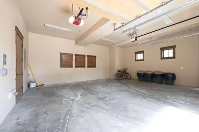 an empty garage with two bikes parked in it at The Shores Riverside Townhome: Peaceful Luxury in Breckenridge