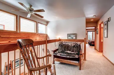 a room with a rocking chair and a ceiling fan at Village Townhome: Views, Location in Frisco