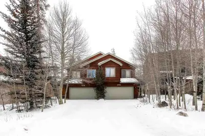 a house with a garage in the snow at Village Townhome: Views, Location in Frisco