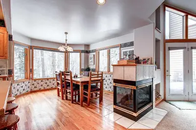 a living room with a fireplace and a table and chairs at Village Townhome: Views, Location in Frisco