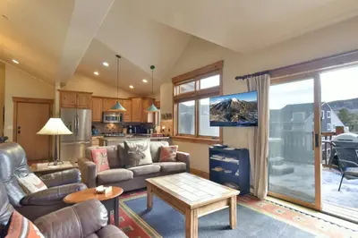 a living room with a couch and a table at Mt. Victoria Lodge Penthouse Condo: Downtown, Hot Tub in Frisco
