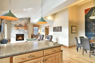 a kitchen and living room with a fireplace at Mt. Victoria Lodge Penthouse Condo: Downtown, Hot Tub in Frisco