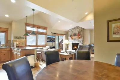 a kitchen and dining room with a table and chairs at Mt. Victoria Lodge Penthouse Condo: Downtown, Hot Tub in Frisco
