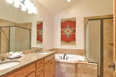 a bathroom with two sinks and a tub and a shower at Mt. Victoria Lodge Penthouse Condo: Downtown, Hot Tub in Frisco