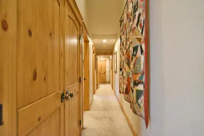 a hallway with wooden cabinets and a hallway with a hallway at Mt. Victoria Lodge Penthouse Condo: Downtown, Hot Tub in Frisco