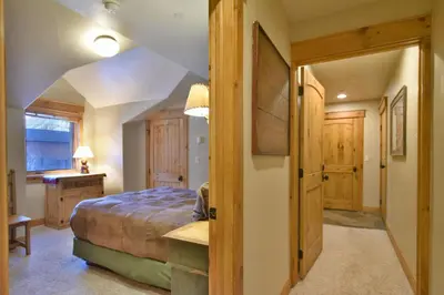 a bedroom with a bed and a desk in a room at Mt. Victoria Lodge Penthouse Condo: Downtown, Hot Tub in Frisco