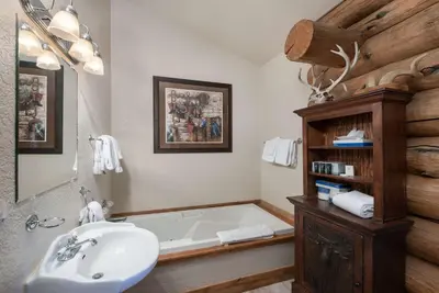 a bathroom with a bath tub and a sink at Swan River Lodge Home: Spacious, Hot Tub in Breckenridge