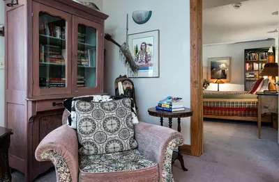 a living room with a chair and a bedroom at Swan River Lodge Home: Spacious, Hot Tub in Breckenridge