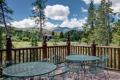 a patio with tables and chairs on a deck at Swan River Lodge Home: Spacious, Hot Tub in Breckenridge